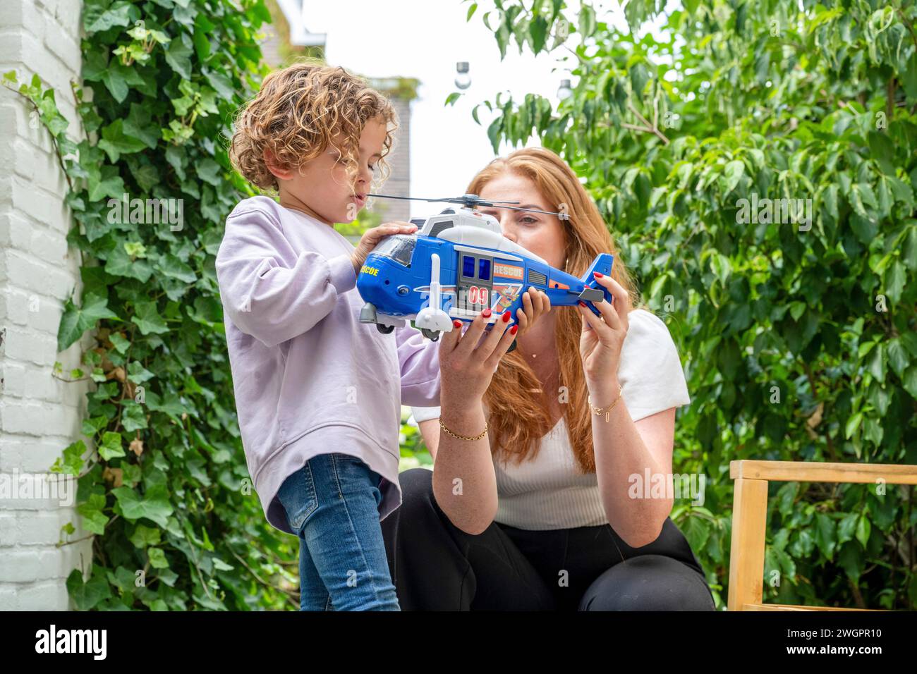 Mother and son playing and bonding in the garden Stock Photo