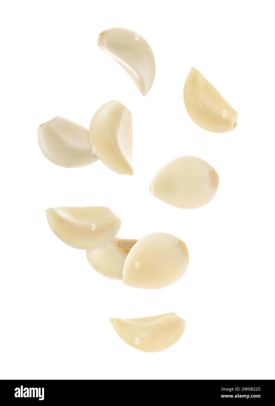 Fresh garlic cloves falling on white background Stock Photo