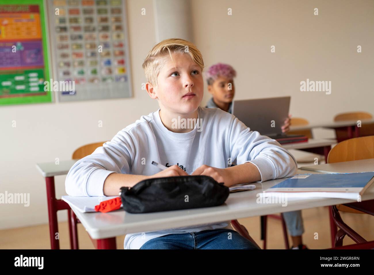 teenage students in class concentrating on their teacher Stock Photo