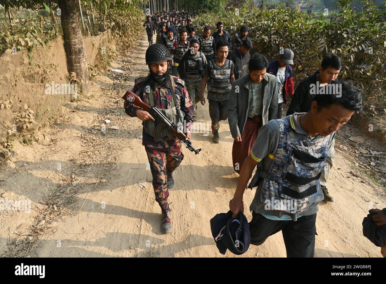 Cox's Bazar district in Bangladesh. 6 Feb, 2024. Border Guard Bangladesh (BGB) personnel detain Myanmar's Border Guard Police (BGP) and security forces personnel seeking refuge in Bangladesh's Ukhia along the Bangladesh-Myanmar border, in Cox's Bazar district in Bangladesh, on February 6, 2024. At lest 264 members of Myanmar's border and security forces have come to Bangladesh to escape the fighting between the Myanmar army and the rebel Arakan Army at the border between the two countries, according to the Border Guard Bangladesh (BGB). Credit: Mamunur Rashid/Alamy Live News Stock Photo