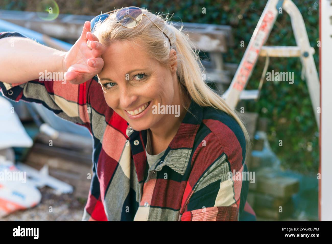 Attractive single mum washing windows and doing DIY Stock Photo