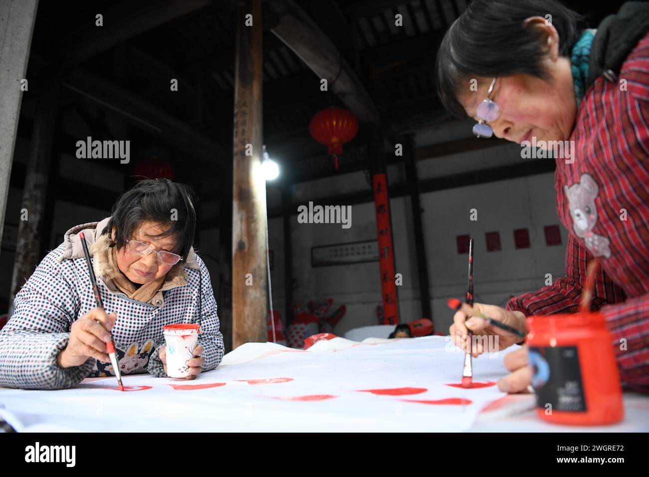 (240206) -- SHEXIAN, Feb. 6, 2024 (Xinhua) -- Local residents make fish-shaped lanterns in Zhanqi Village of Shexian County, Huangshan City, east China's Anhui Province, Feb. 4, 2024. The parade with fish-shaped lanterns is an important folk cultural activity in Shexian County. Every year, in the first month of Chinese lunar calendar, it attracts tourists from all over the country.   Born in 1996, Wang Yufang is an inheritor of fish-shaped lantern making skills, an intangible cultural heritage. Wang started to learn the skills from local villagers when he was 12 years old.     Wang now runs a Stock Photo