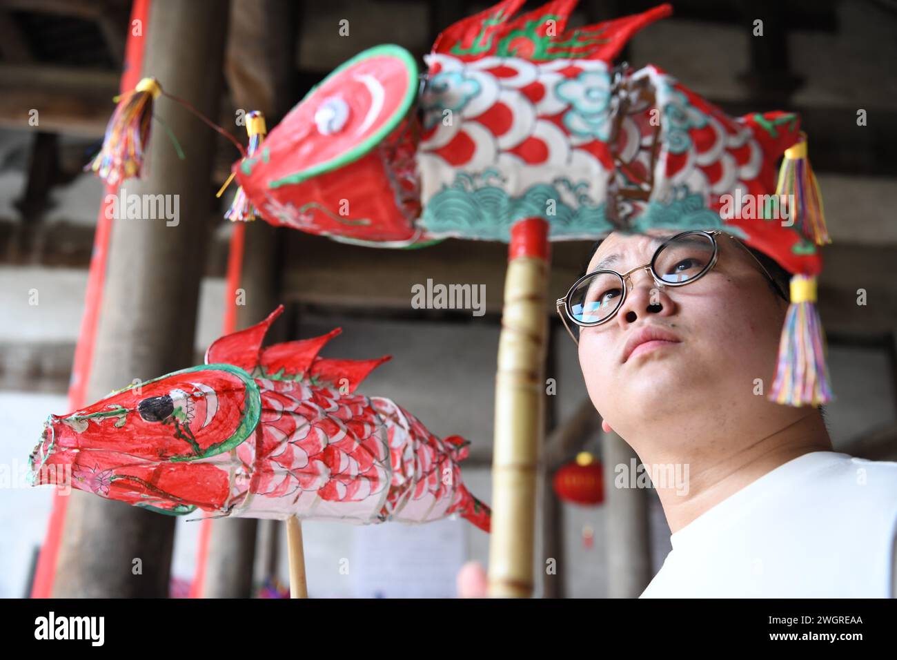 (240206) -- SHEXIAN, Feb. 6, 2024 (Xinhua) -- Wang Yufang shows finished fish-shaped lanterns in Zhanqi Village of Shexian County, Huangshan City, east China's Anhui Province, Sept. 6, 2023. The parade with fish-shaped lanterns is an important folk cultural activity in Shexian County. Every year, in the first month of Chinese lunar calendar, it attracts tourists from all over the country. Born in 1996, Wang Yufang is an inheritor of fish-shaped lantern making skills, an intangible cultural heritage. Wang started to learn the skills from local villagers when he was 12 years old. Wang now Stock Photo