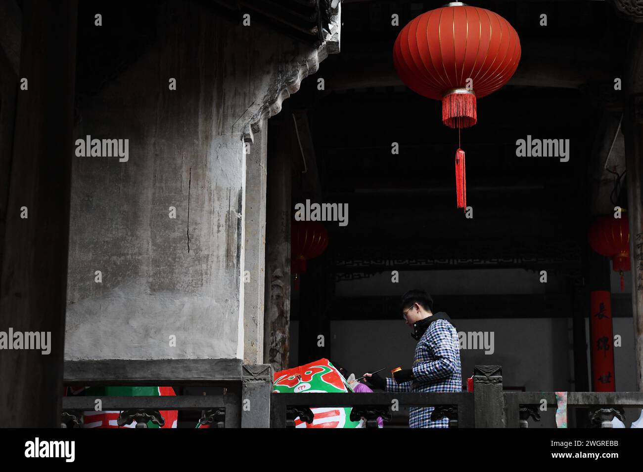 (240206) -- SHEXIAN, Feb. 6, 2024 (Xinhua) -- University student Wang Yuxin makes fish-shaped lanterns in Zhanqi Village of Shexian County, Huangshan City, east China's Anhui Province, Feb. 4, 2024. The parade with fish-shaped lanterns is an important folk cultural activity in Shexian County. Every year, in the first month of Chinese lunar calendar, it attracts tourists from all over the country.   Born in 1996, Wang Yufang is an inheritor of fish-shaped lantern making skills, an intangible cultural heritage. Wang started to learn the skills from local villagers when he was 12 years old.     W Stock Photo