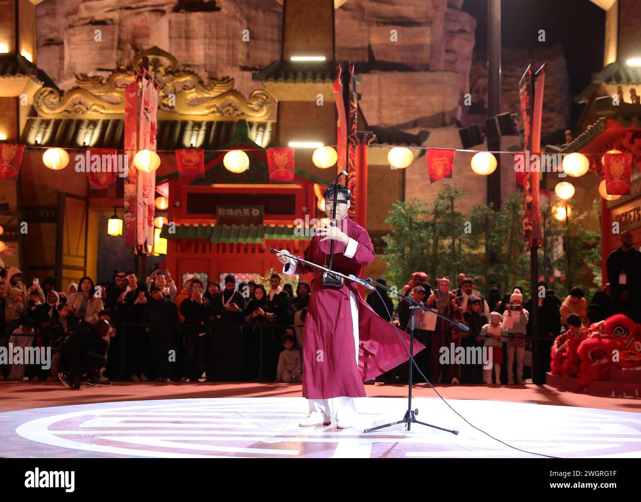 Riyadh, Saudi Arabia. 5th Feb, 2024. An actor plays erhu, a traditional musical instrument in China, during an event celebrating the upcoming Chinese Lunar New Year, or the Spring Festival, at the Chinatown of the Boulevard World in Riyadh, Saudi Arabia, on Feb. 5, 2024. Credit: Wang Dongzhen/Xinhua/Alamy Live News Stock Photo