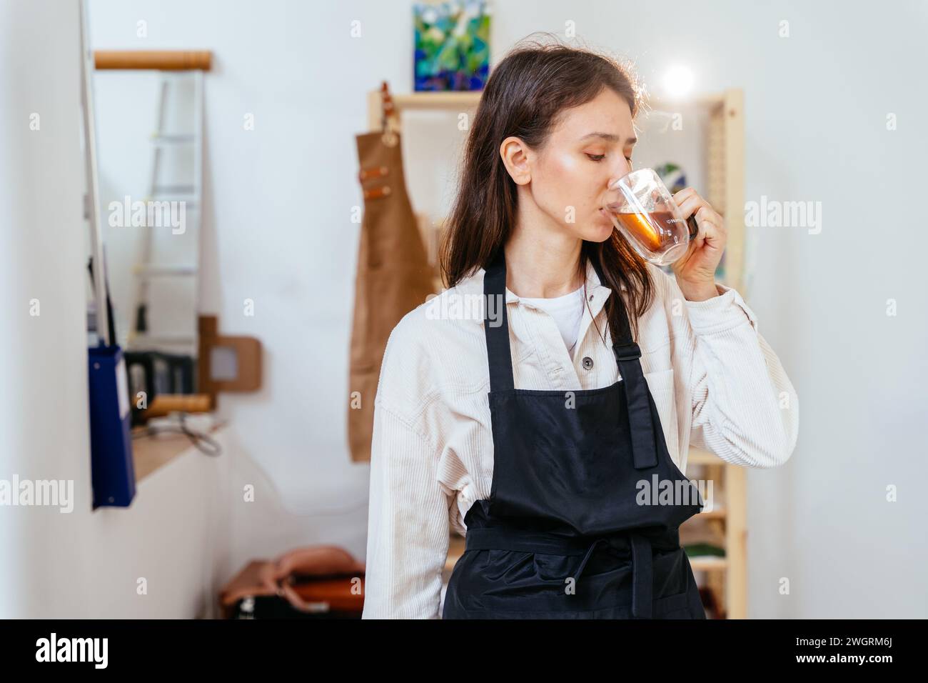 Portrait of positive female creator stained glass windows relaxing ...