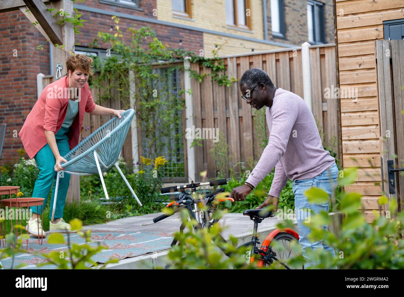 Mixed race parents cleaning the garden Stock Photo