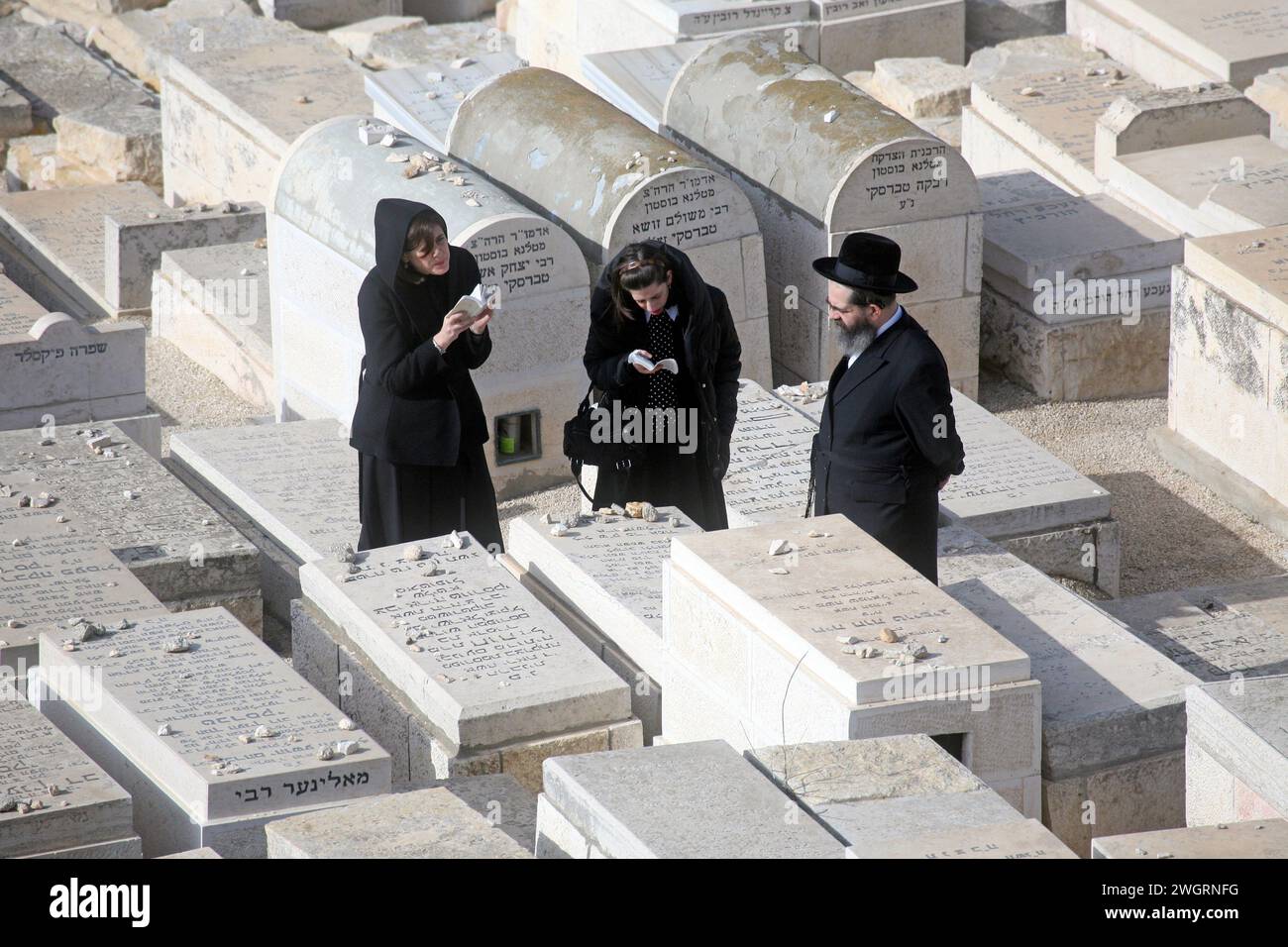 Orthodox Jews praying in the cemetery on the Mount Olives in Jerusalem, Israel Stock Photo