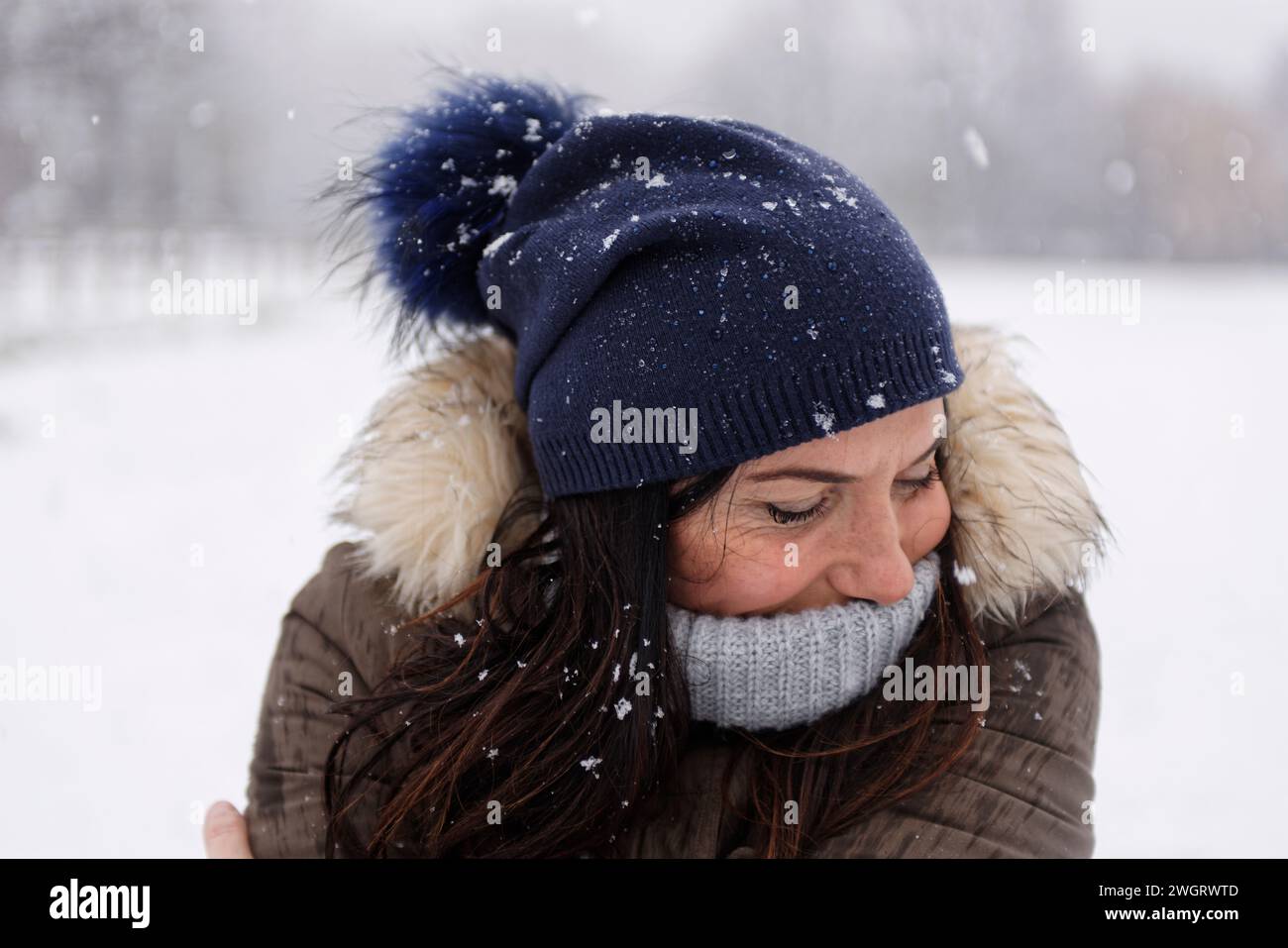 Woman under a snowfall, Milan, Italy Stock Photo