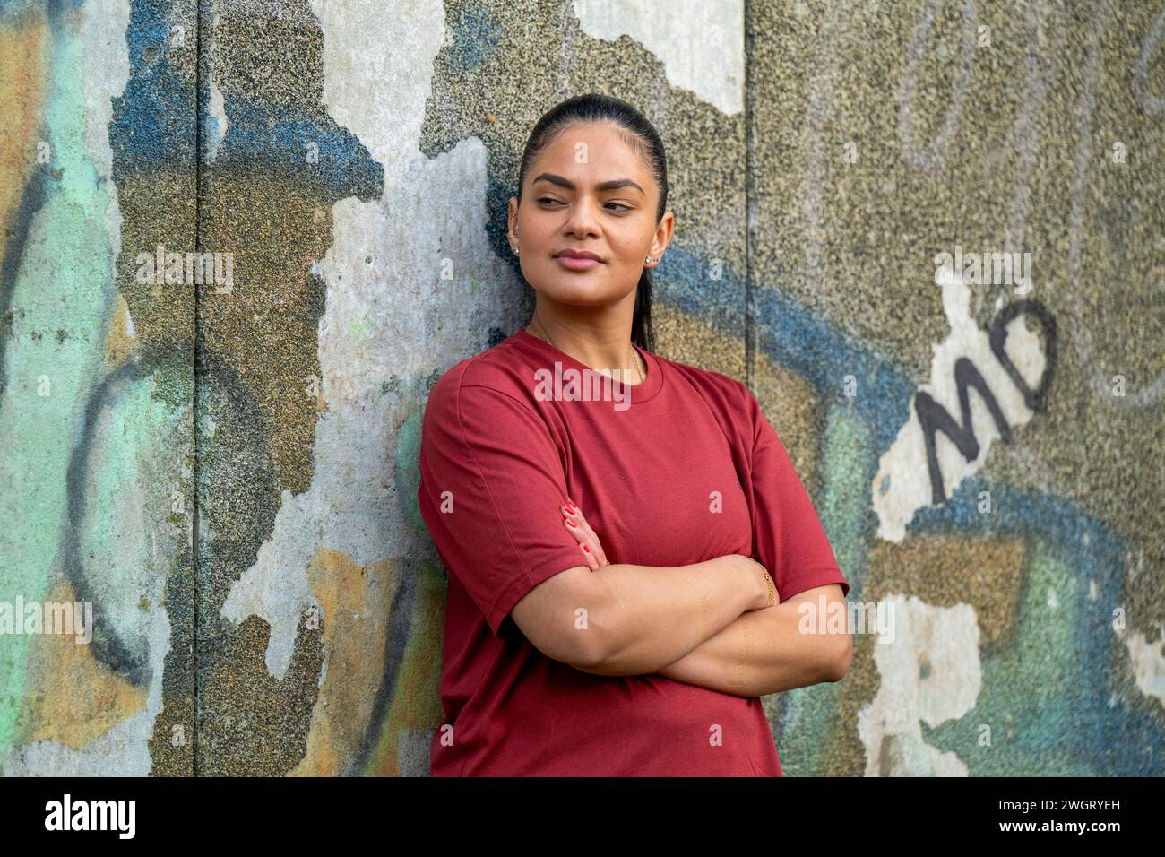 Portrait of a healthy woman leaning on a wall Stock Photo