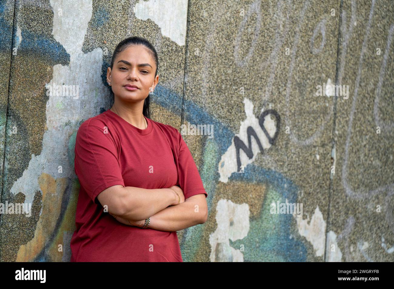 Portrait of a healthy woman leaning on a wall Stock Photo