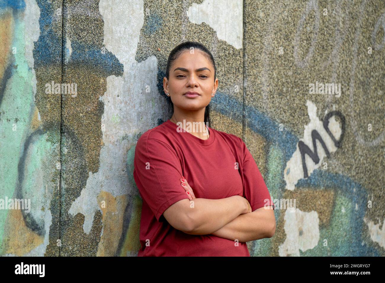 Portrait of a healthy woman leaning on a wall Stock Photo