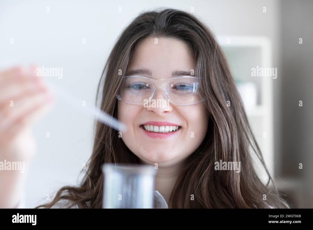 scientist young woman working in a labor with lab glasses Stock Photo