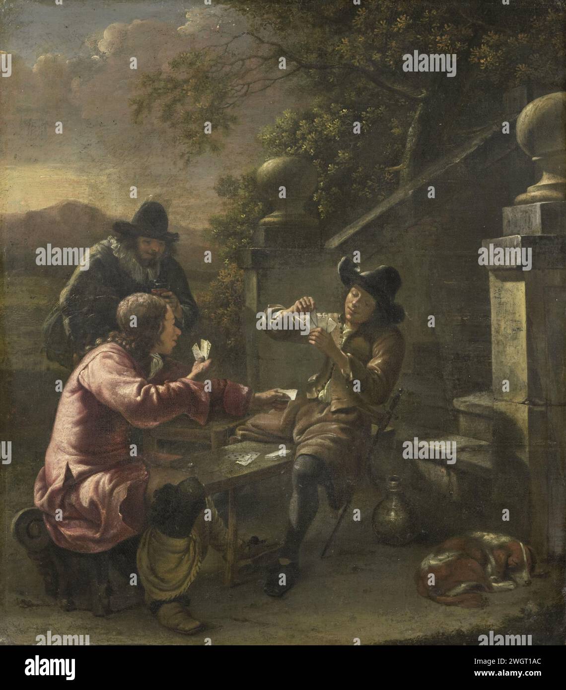 The card players, Johannes Natus, 1660 painting The card players. Seated at a table at the foot of a stone staircase, two young men play a card game, a standing man watches, a dog is sleeping on the right.  canvas. oil paint (paint)  playing-cards Stock Photo