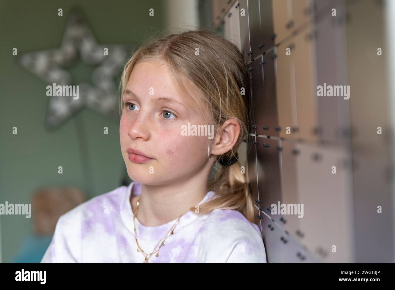 Young girl teenager leaning on the wall relaxing Stock Photo
