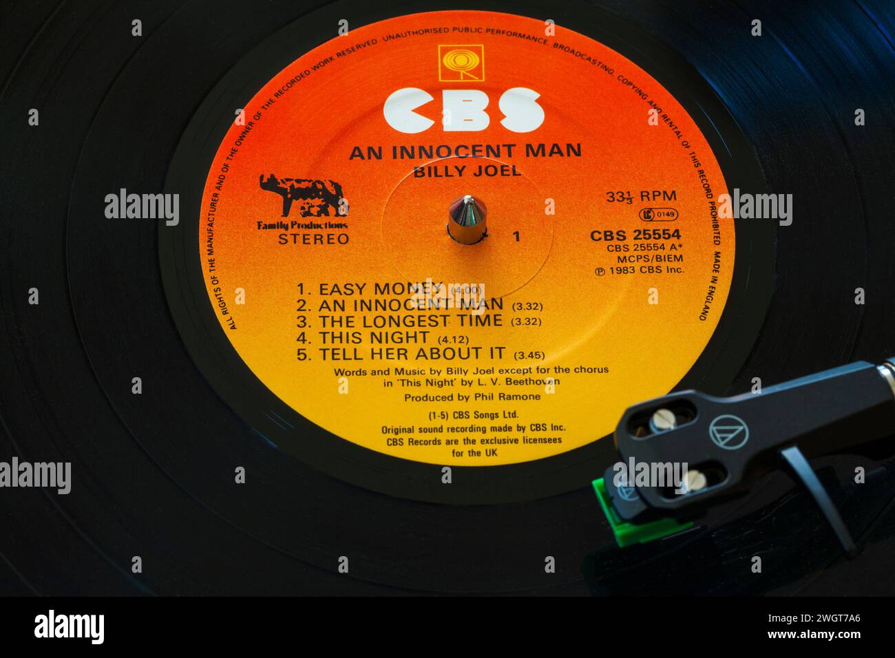Billy Joel Innocent Man vinyl record album LP with tonearm, cartridge, headshell and stylus on turntable record player - 1983 Stock Photo