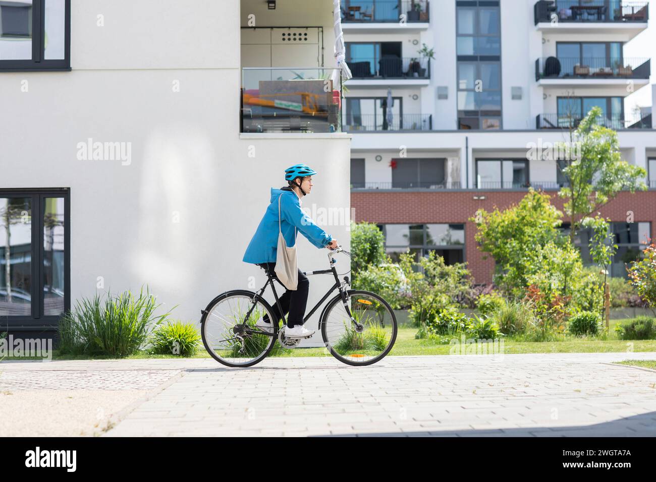 Young man biking in the city with helmet Stock Photo