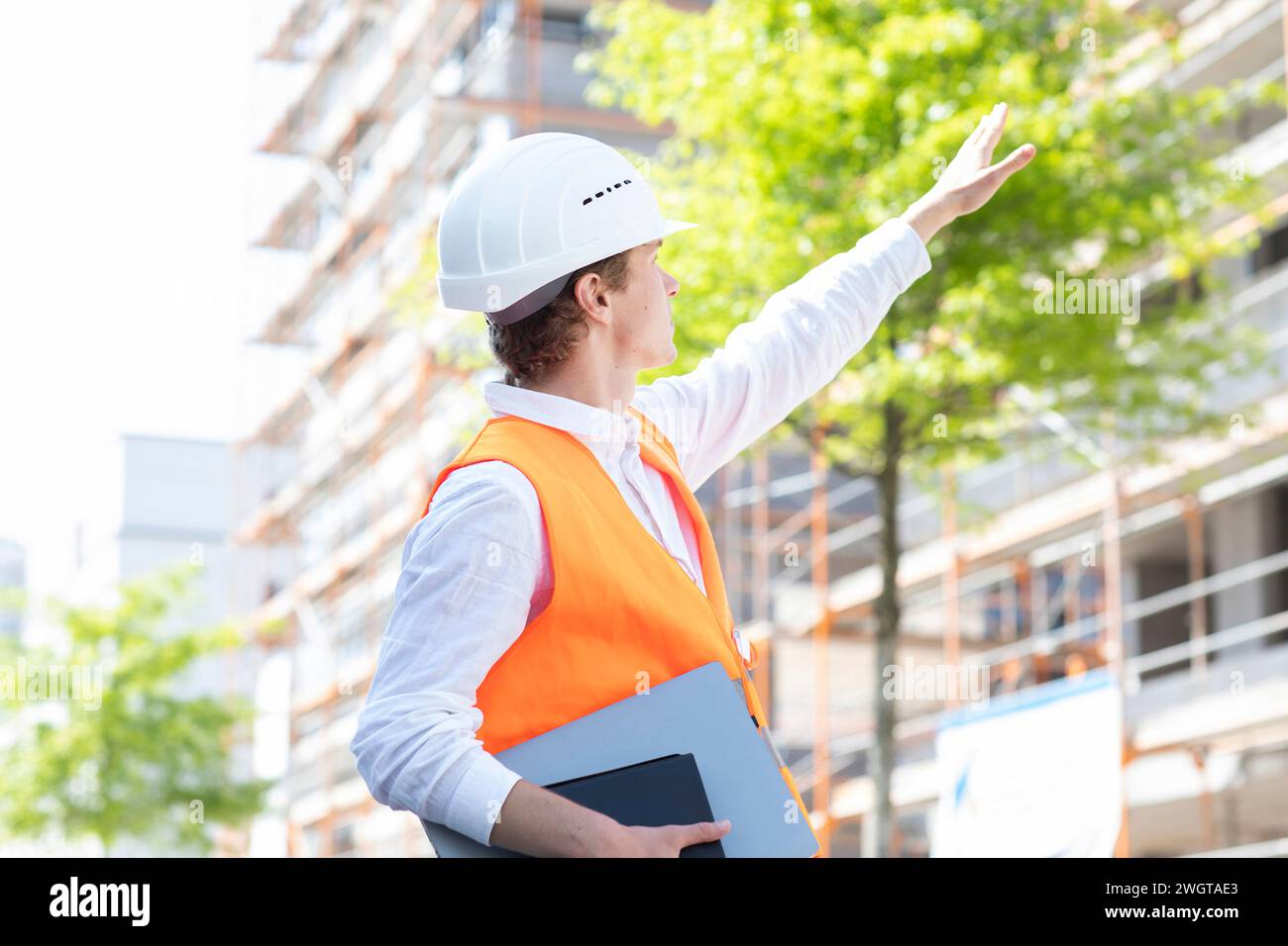 Engineer with helmet working outside new building Stock Photo