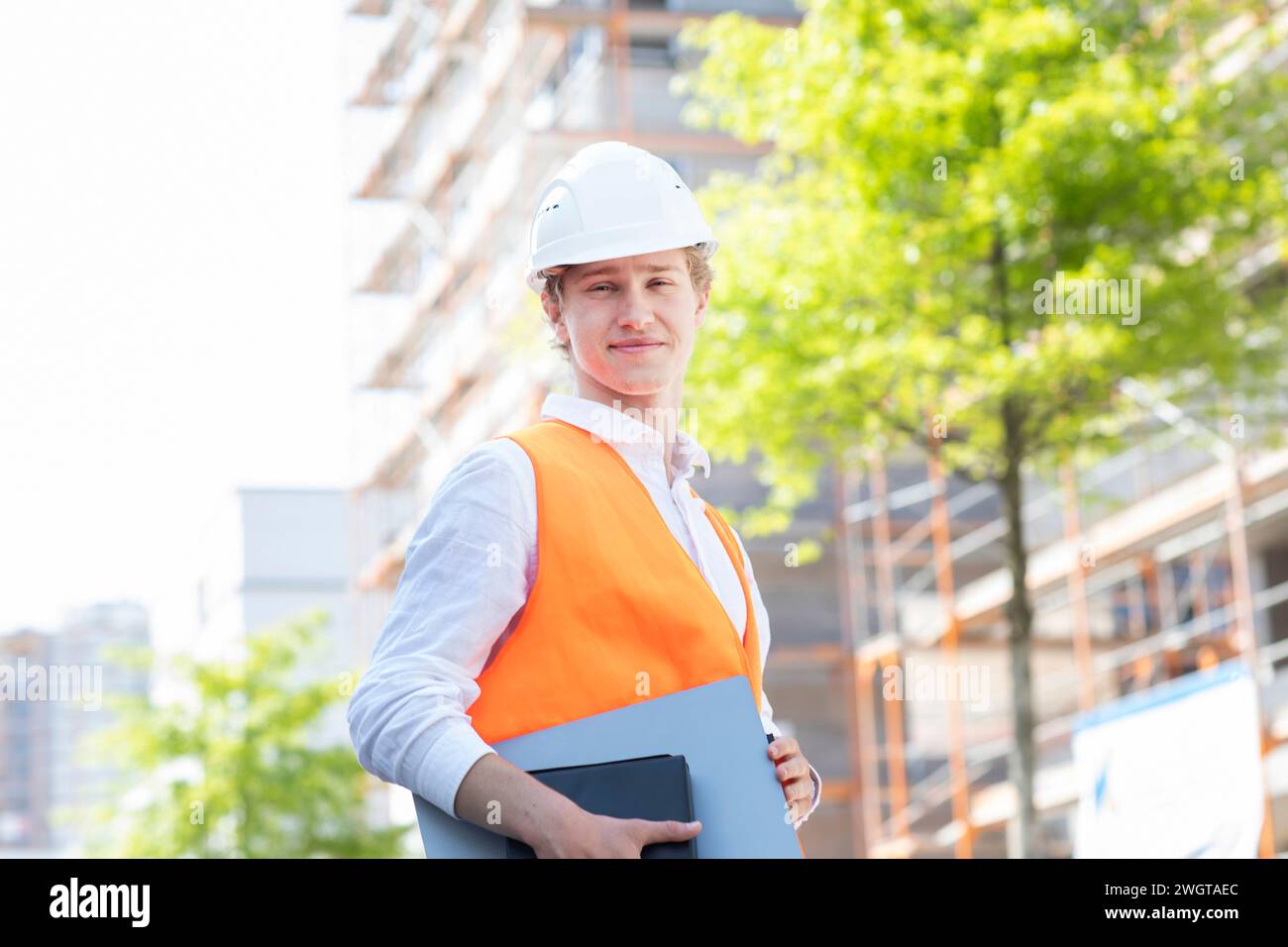 Engineer with helmet working outside new building Stock Photo
