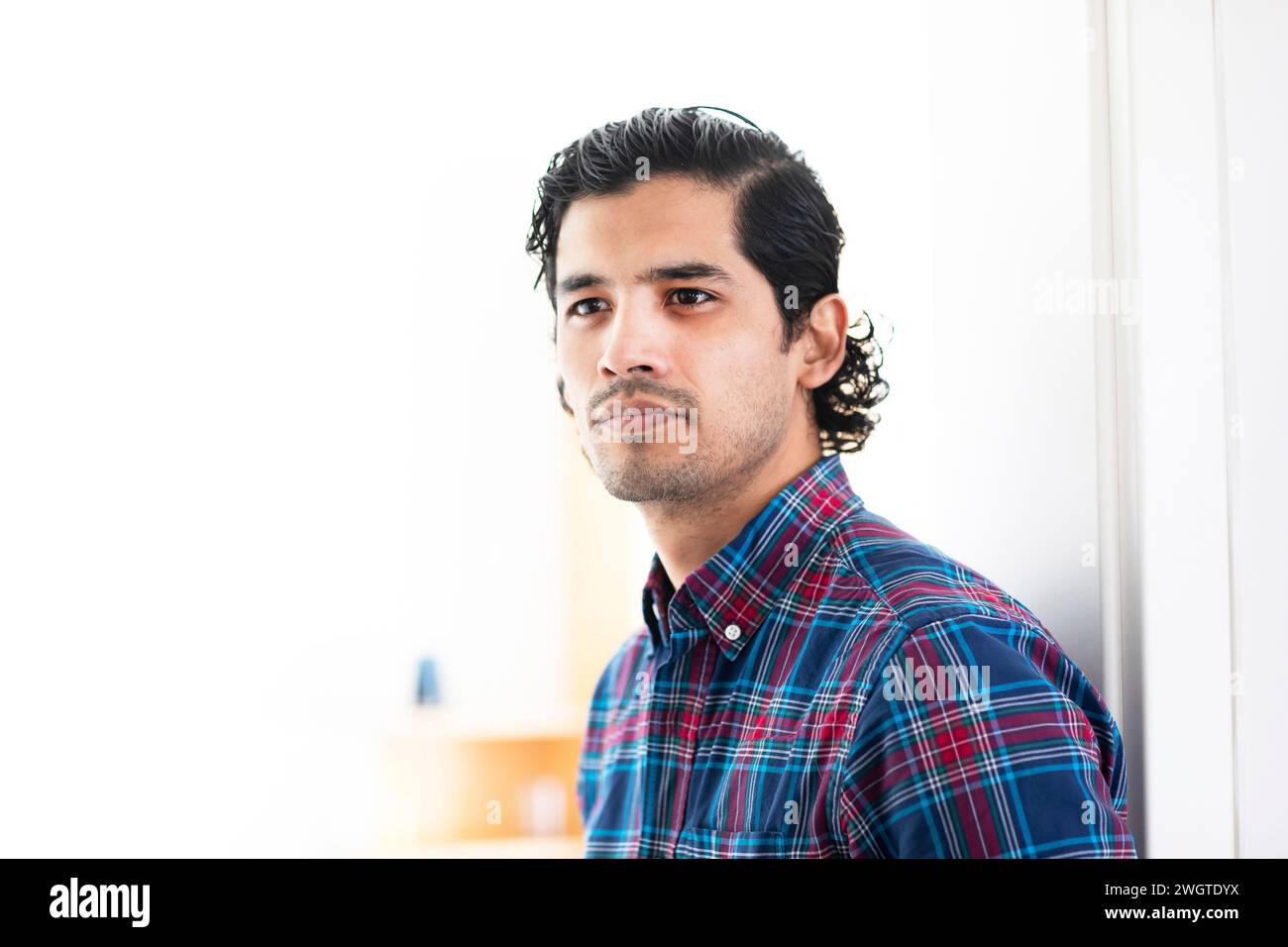 Yong man standing at home calm Stock Photo