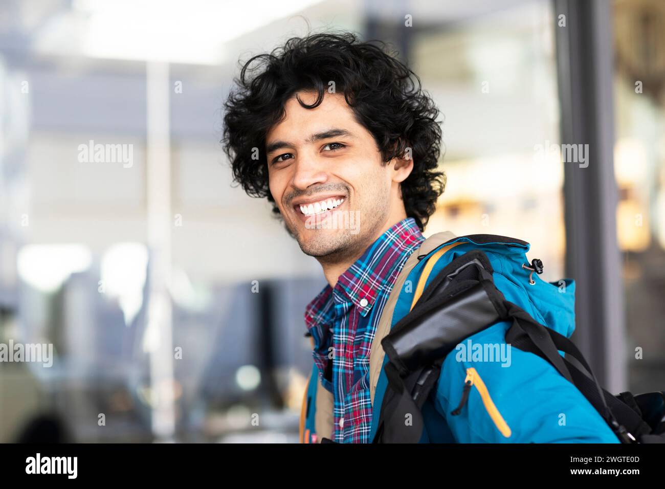 Young man outside with bag Stock Photo