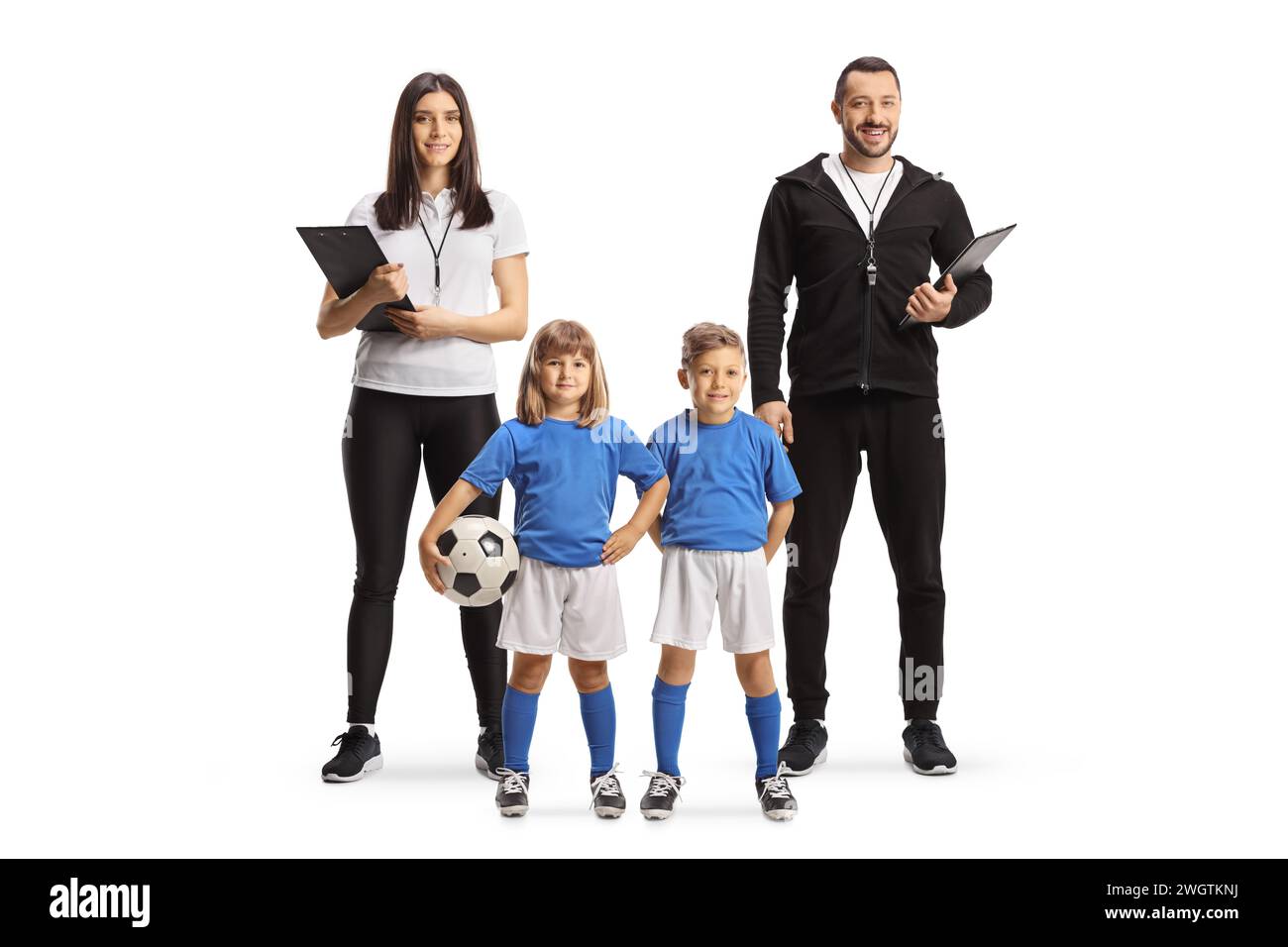 Football coaches with children in kits posing and looking at camera isolated on white background Stock Photo