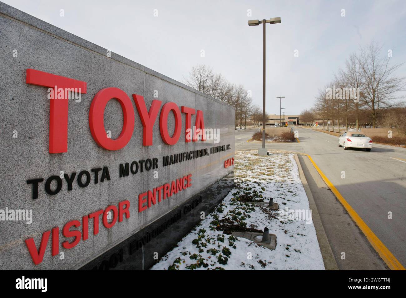 FILE - A car drives past the entrance to the Toyota Motor Manufacturing ...