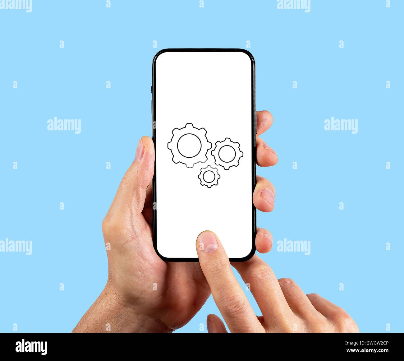Adjusting mobile phone settings, smartphone cogwheel icon on screen Stock Photo