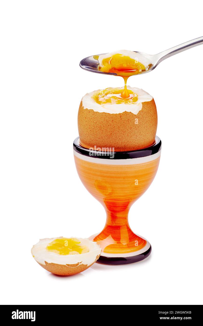 Soft-boiled egg in cup with spoon isolated on white Stock Photo