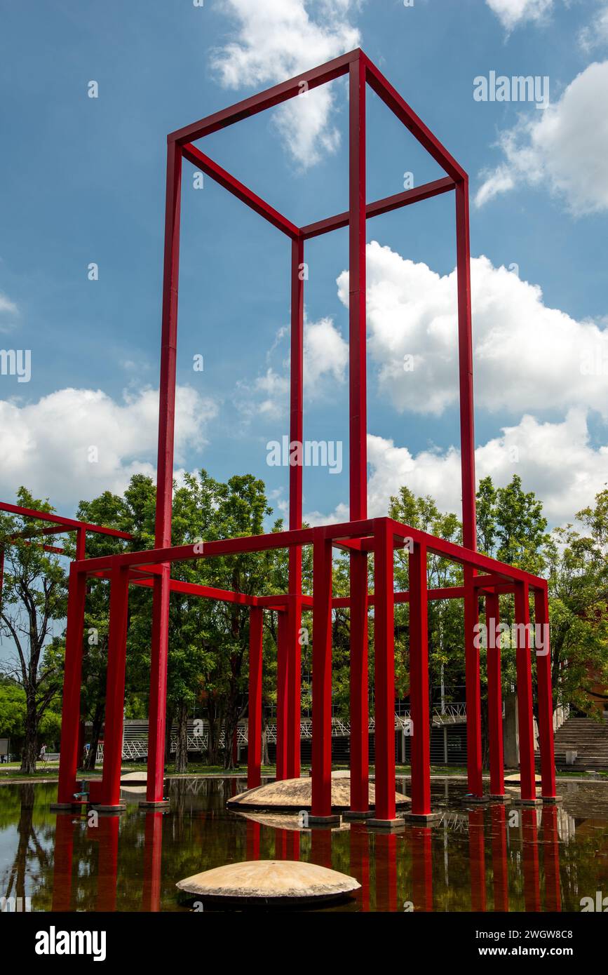 Sculpture atop water beside a clock tower Stock Photo