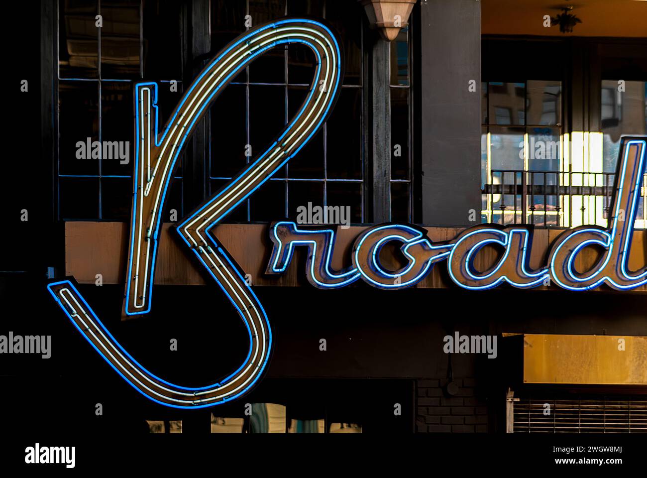 Illuminated blue and yellow Broadway sign Stock Photo - Alamy