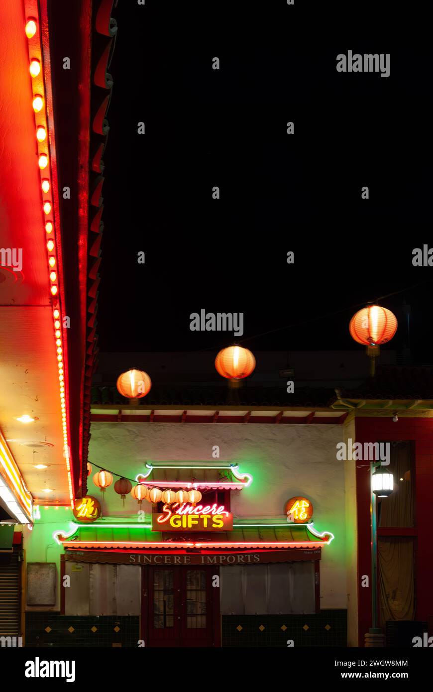 Illuminated building adorned with vibrant red and green signs and lights Stock Photo