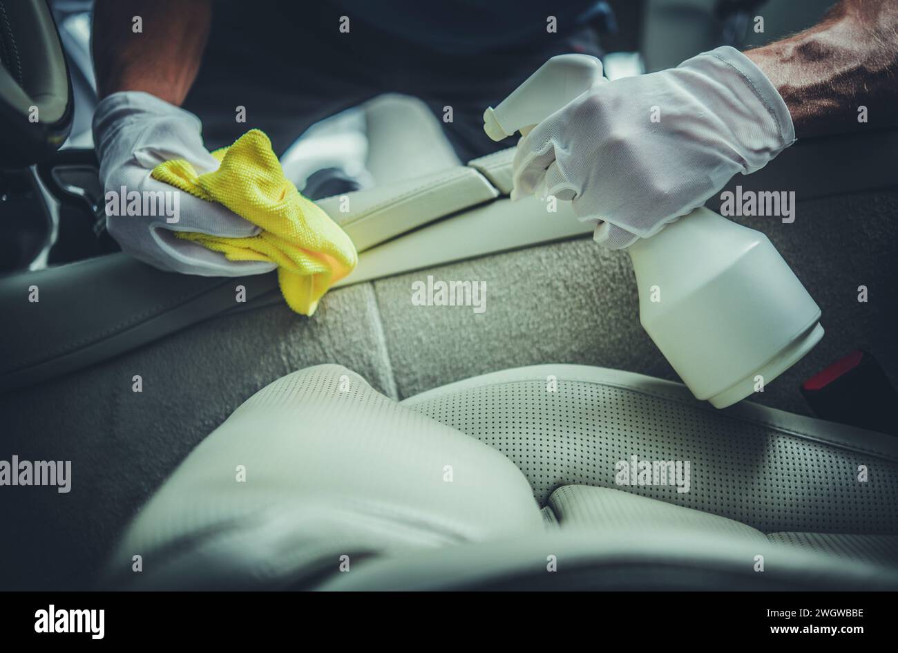 Modern Car Leather Seats Cleaning Detergent. Worker Cleaning a Car