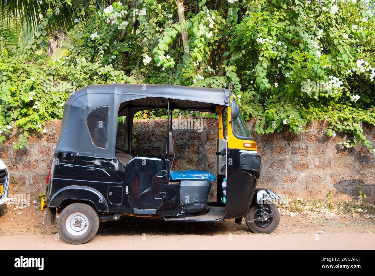 Agonda, Goa, India, Black tuk tuk in the street, Editorial only. Stock Photo