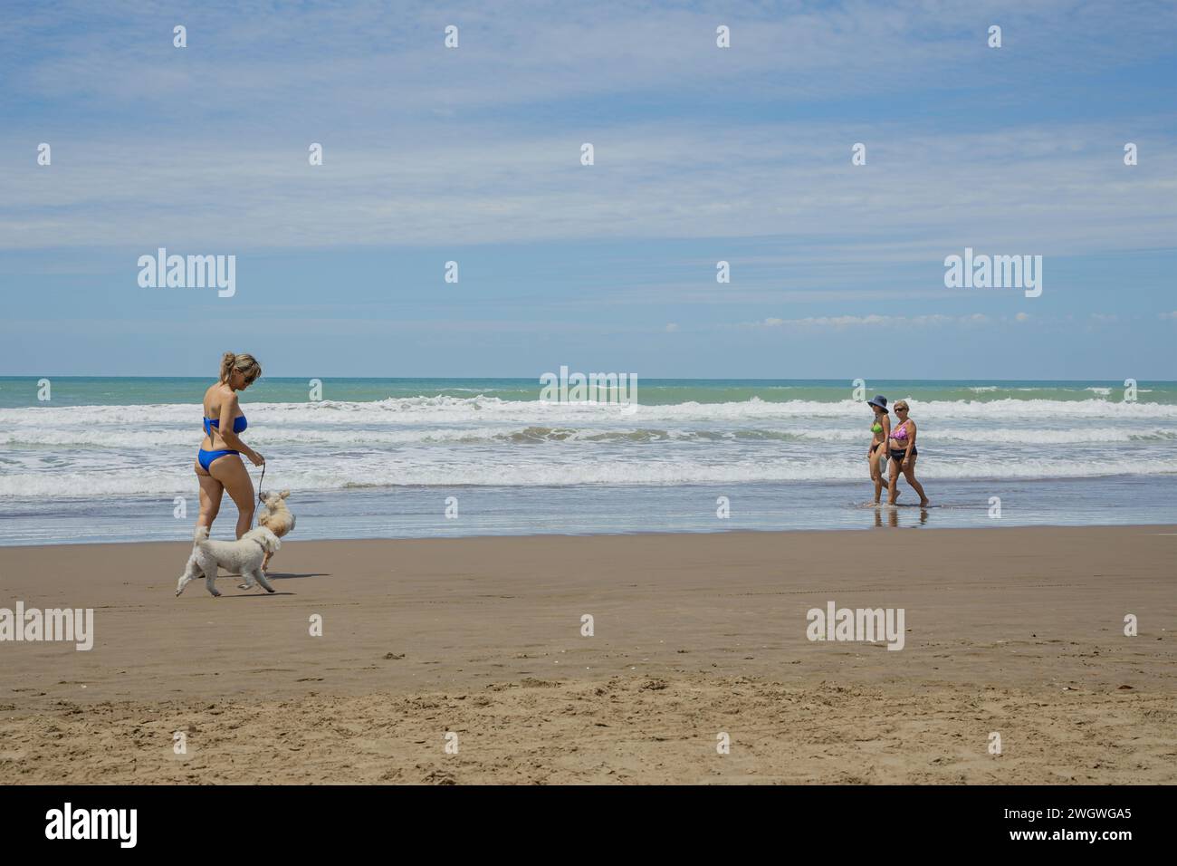 Mar del Plata, Argentina - January 15th, 2024: People walk along the beach of the port of Mar del Plata. Stock Photo