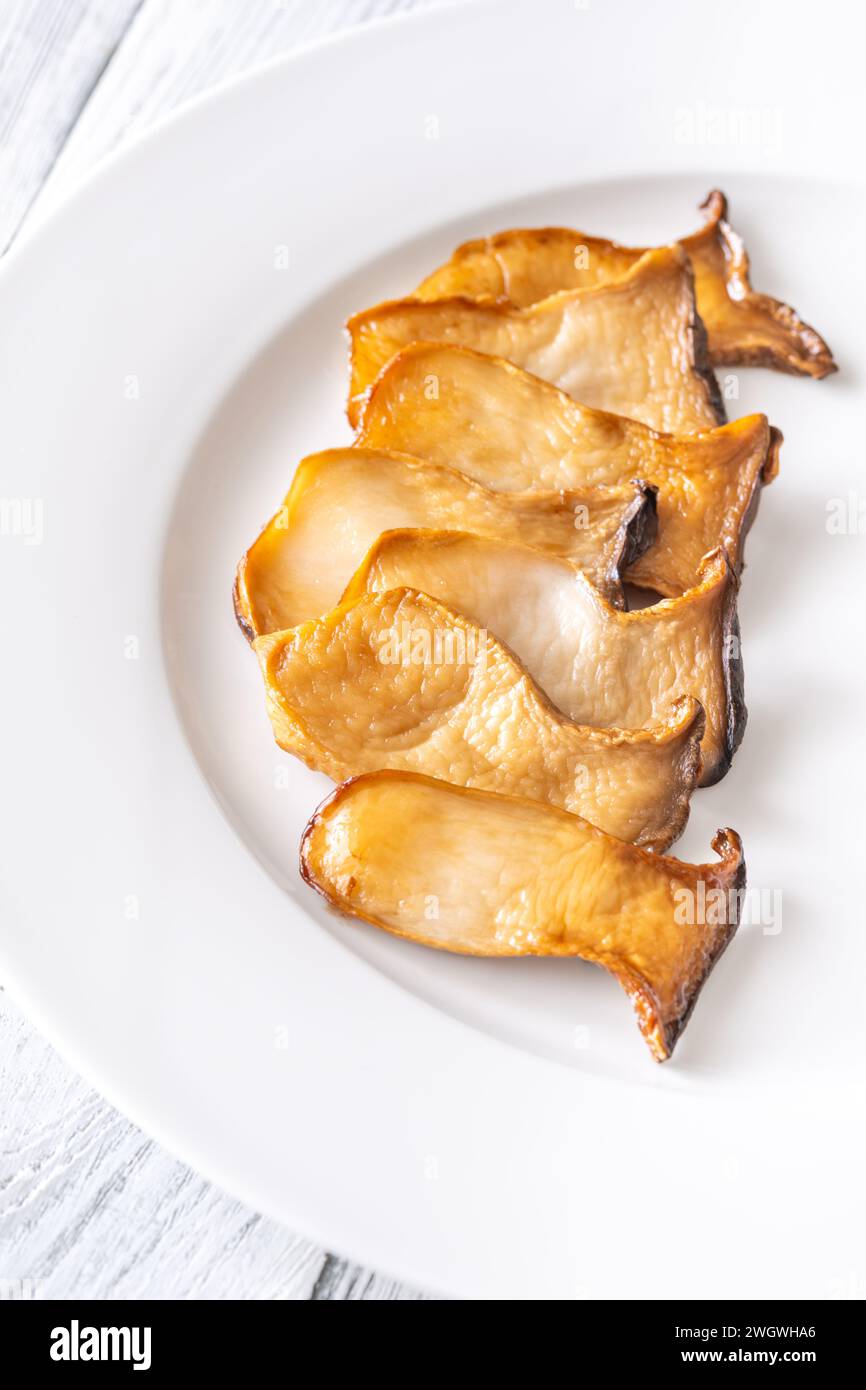 Portion of fried eryngii mushrooms on the plate Stock Photo