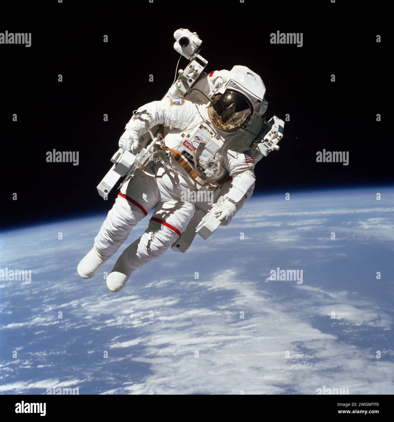 S84-27562 (7 Feb. 1984) --- Astronaut Bruce McCandless II, participating in a historical Extravehicular Activity (EVA), is a few meters away from the cabin of the Earth-orbiting space shuttle Challenger in this 70mm frame. This Extravehicular Activity (EVA) represented the first use of a nitrogen-propelled, hand-controlled device called the Manned Maneuvering Unit (MMU), which allows for much greater mobility than that afforded previous spacewalkers who had to use restrictive tethers. Robert L. Stewart later tried out the MMU McCandless is using here, Stock Photo