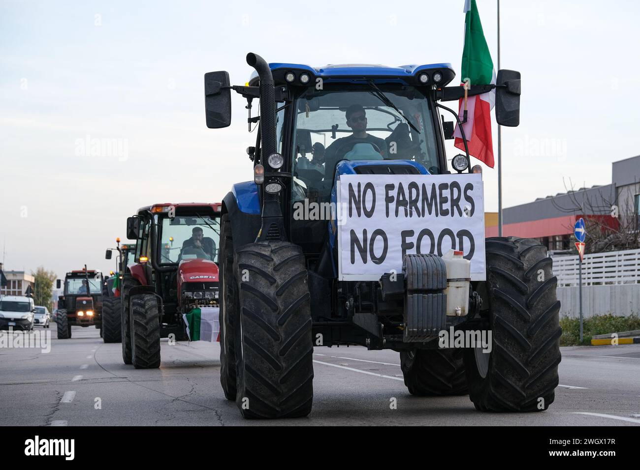 Tractors that reach the square of the garrison. The tractor in the head has a sign that says: 'No Farmers no food'. The protests of the farmers who ga Stock Photo