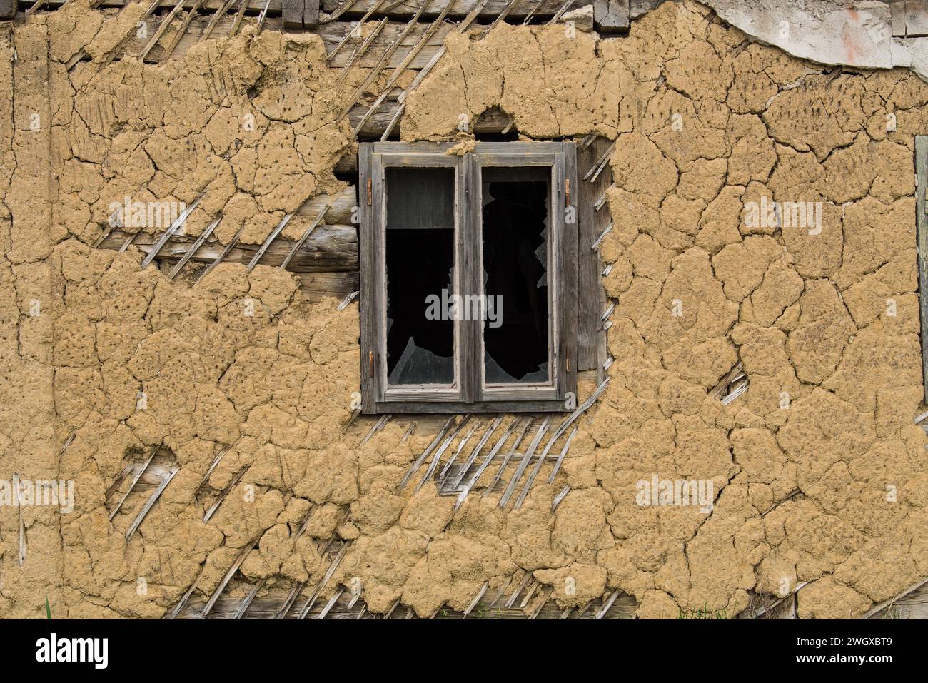 Sunja, Croatia, April 22,2022 : Facade of mud and straw on old wooden house. Stock Photo