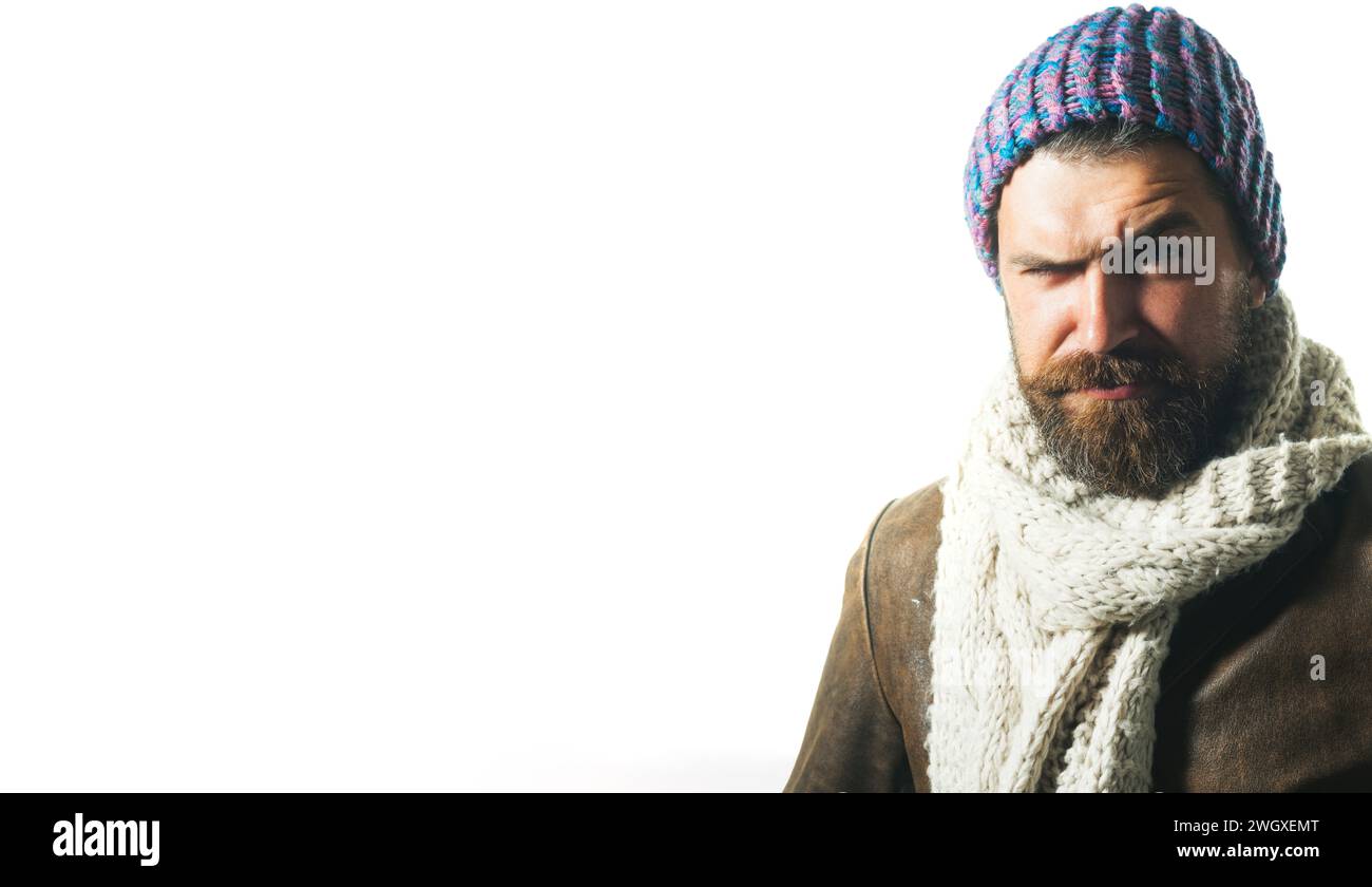 Serious bearded man in leather coat, knitted hat and scarf. Fashionable handsome man with beard and mustache in demi-season clothing. Fashion male Stock Photo