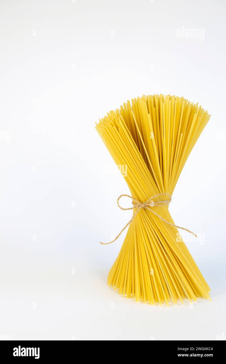 Spaghetti pasta, a bundle of pasta tied with linen thread. The concept ...