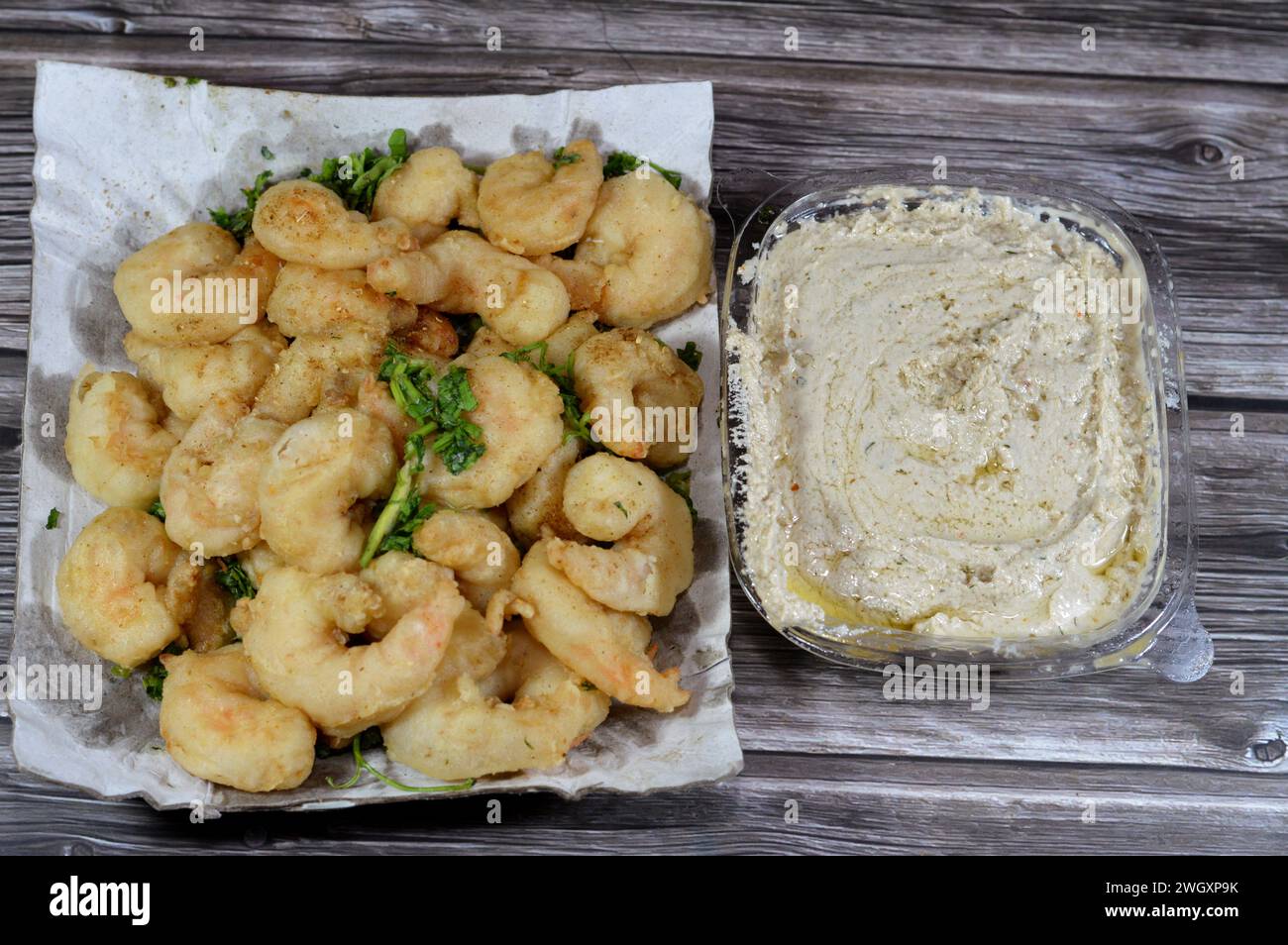 Tahini and Fried shrimps covered with flour and fried in deep hot oil, shrimps are crustacean (a form of shellfish) with an elongated body and a prima Stock Photo