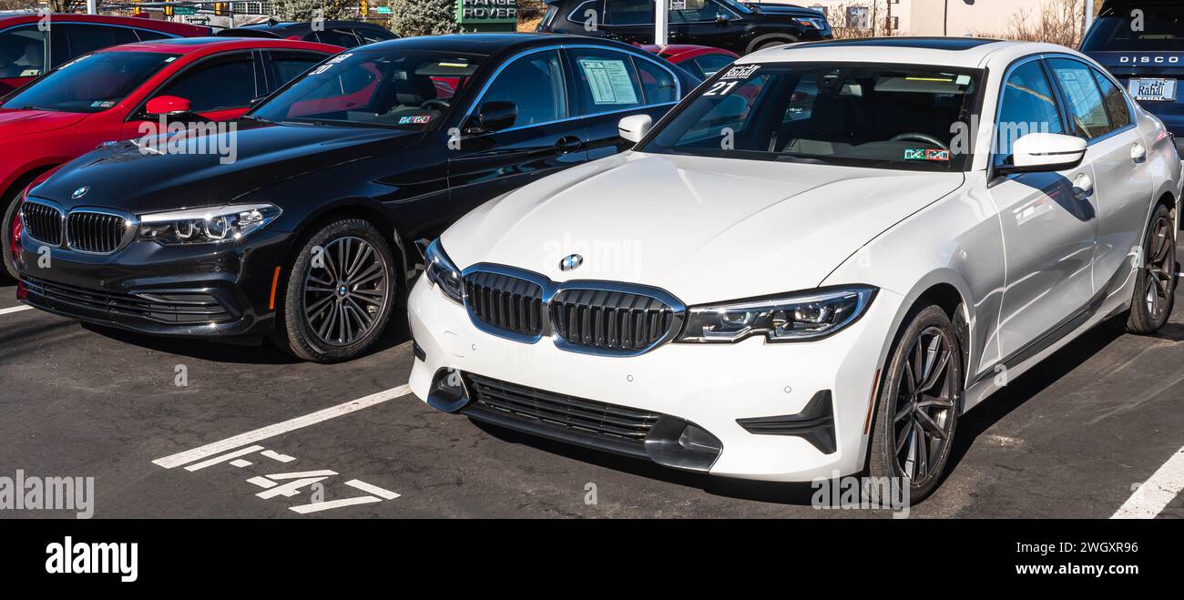 Two used BMW sedans for sale at a dealership Stock Photo