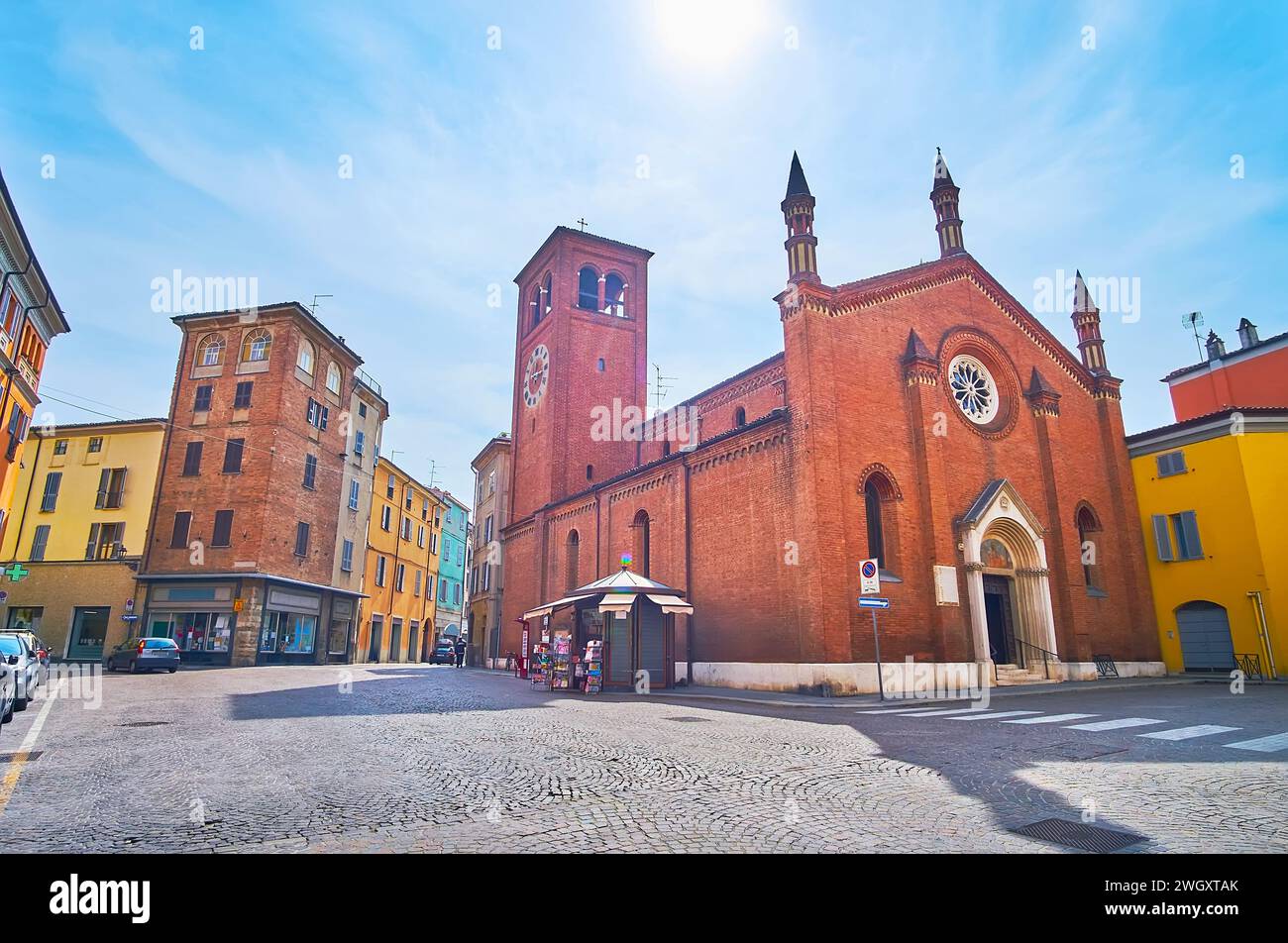 The medieval Piazza del Borgo with Santa Brigida d'Irlanda Church and colored townhouses, Piacenza, Italy Stock Photo