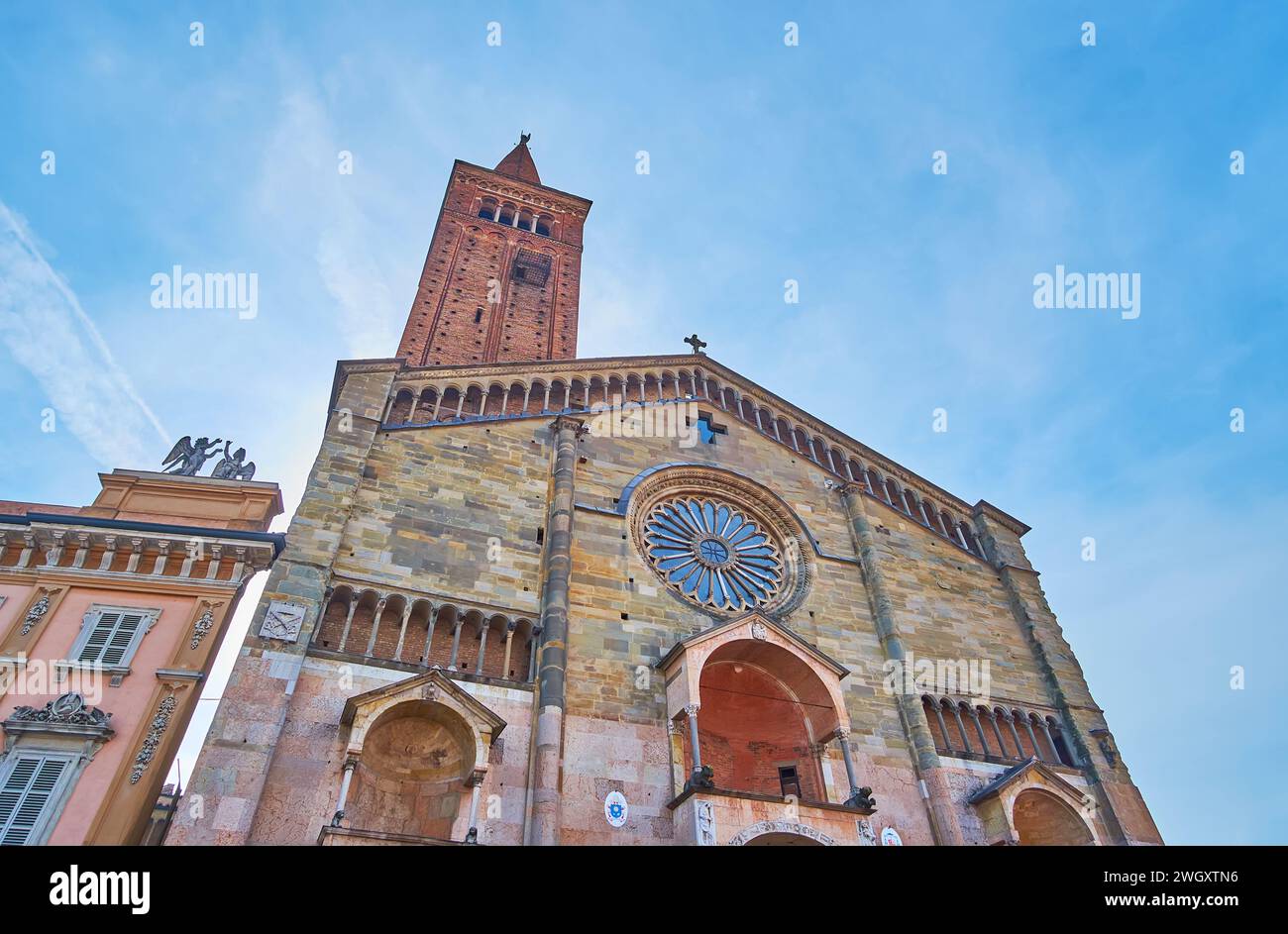 Piacenza Cathedral facade, decorated with rose window, galleries with arcades and protyruses, Italy Stock Photo