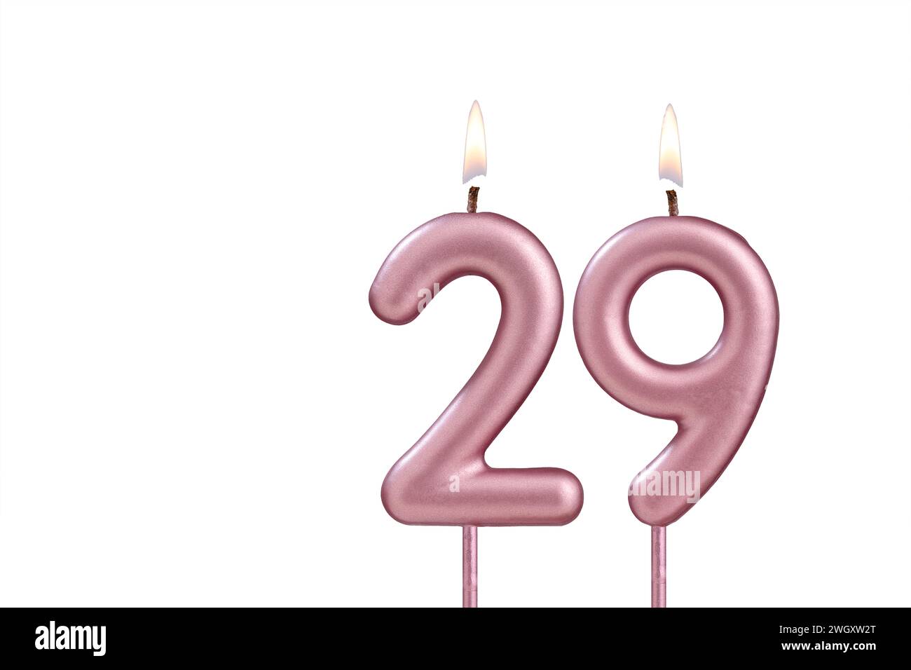 Candle number 29 - Lit birthday candle on white background Stock Photo