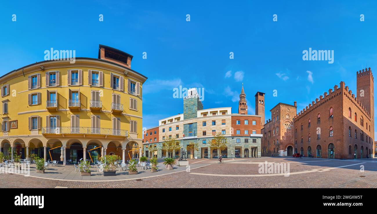 Panorama of the pedestrian Antonio Stradivari Square with modern and medieval buildings, outdoor dining and Town Hall in background, Cremona, Italy Stock Photo
