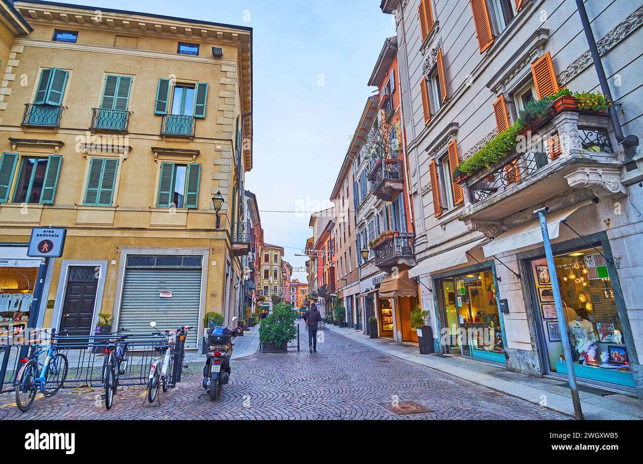 CREMONA, ITALY - APRIL 6, 2022: Via Mercatello with old houses, shops, cafes and small hotels, Cremona,  Italy Stock Photo