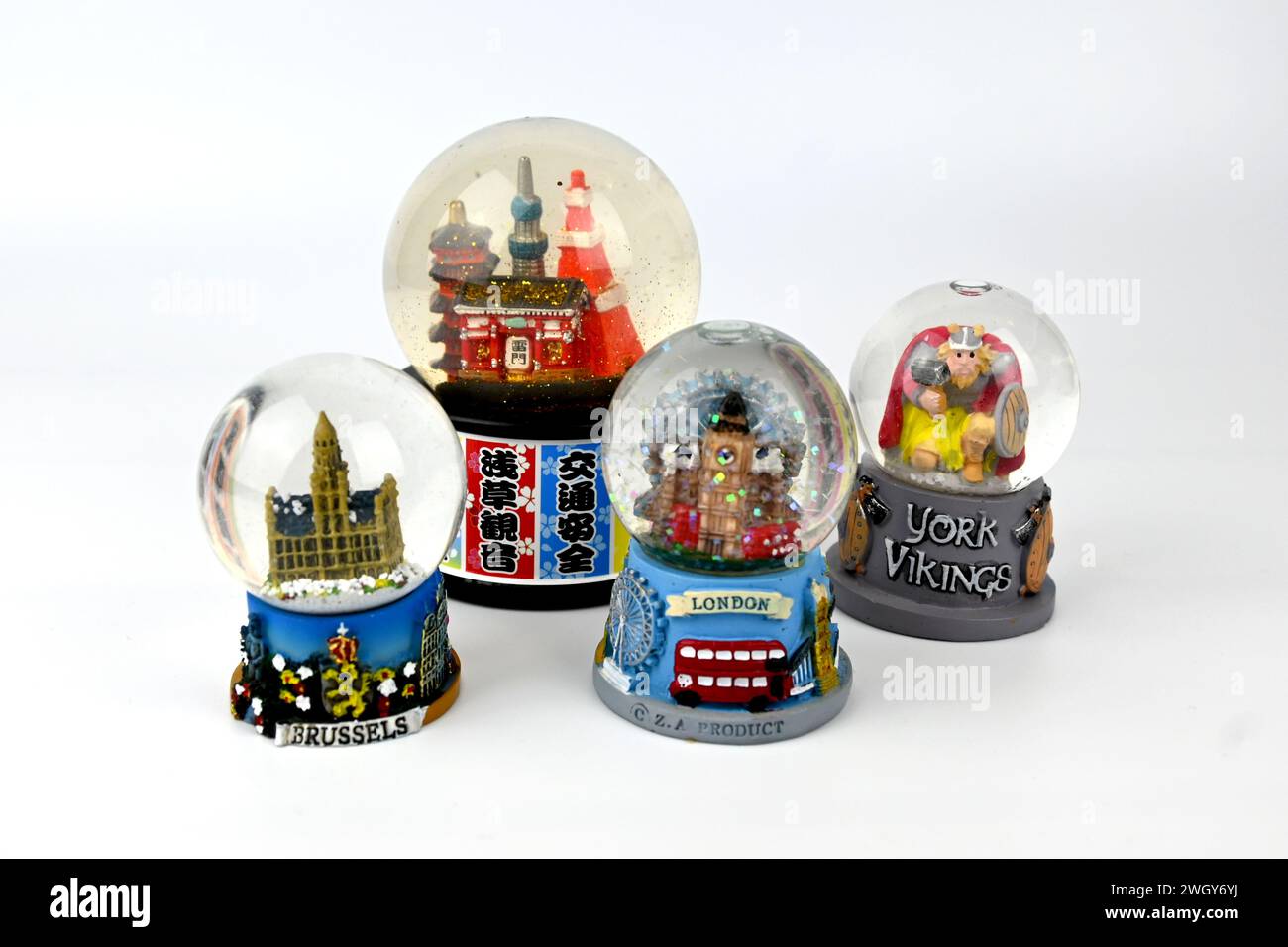 Snow globes souvenirs from different cities on white background – Wales, UK  –  6 February 2024 Stock Photo