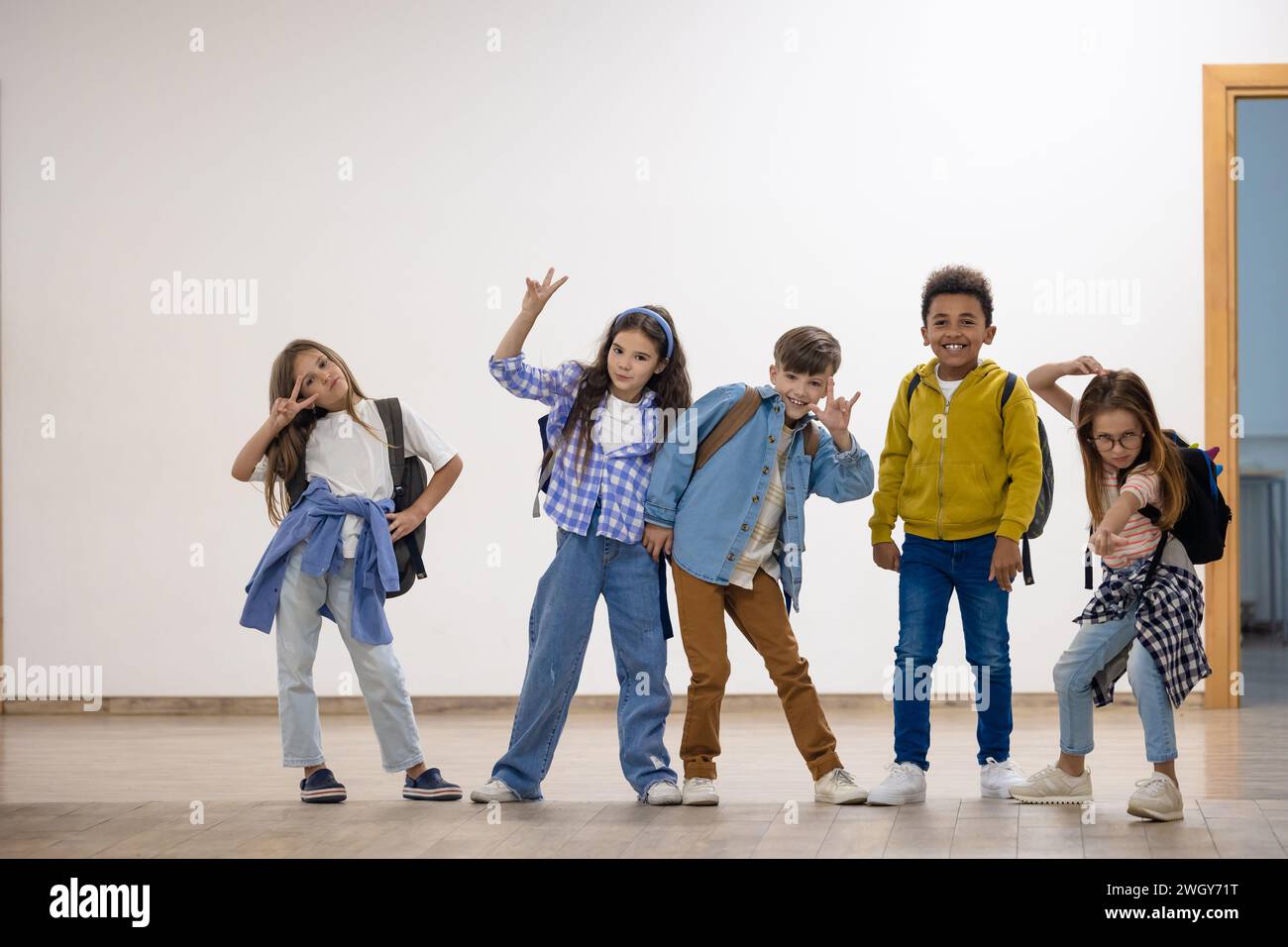 Group of elementary school kids standing in school corridor Stock Photo ...